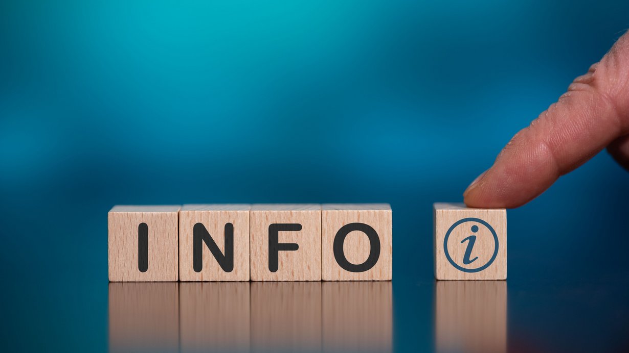 Das bild zeigt 5 Holzwürfel auf türkisfarbenem Hintergrund mit der Aufschrift INFO i