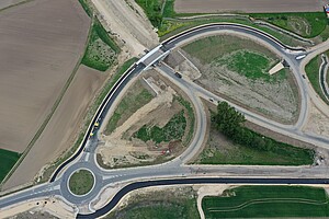 Eine Luftaufnahme mehrerer Straßen. Teile sind neu asphaltiert, andere noch nicht.