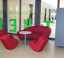 Sitzbereich mit roten Loungemöbeln in der rng-mediathek - nicht öffentliche Zweigstelle der Stadtbücherei Wangen im Rupert-Neß-Gymnasium