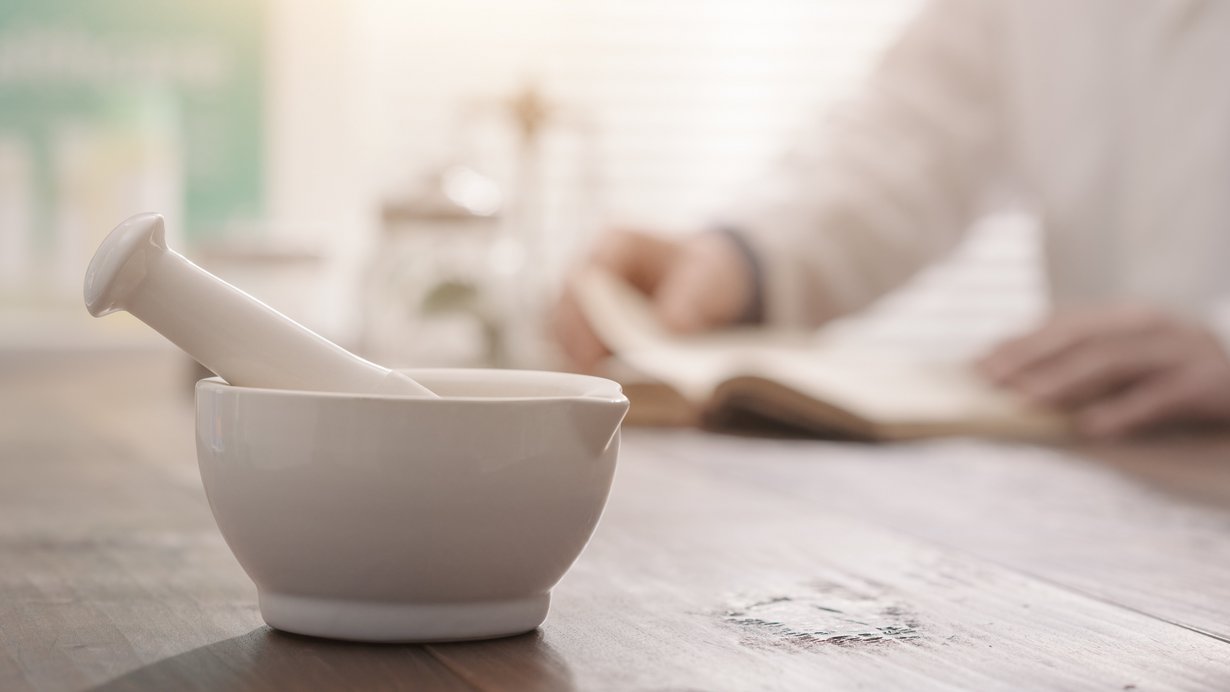 Apotheker mahlt ein Präparat mit einem Mörser